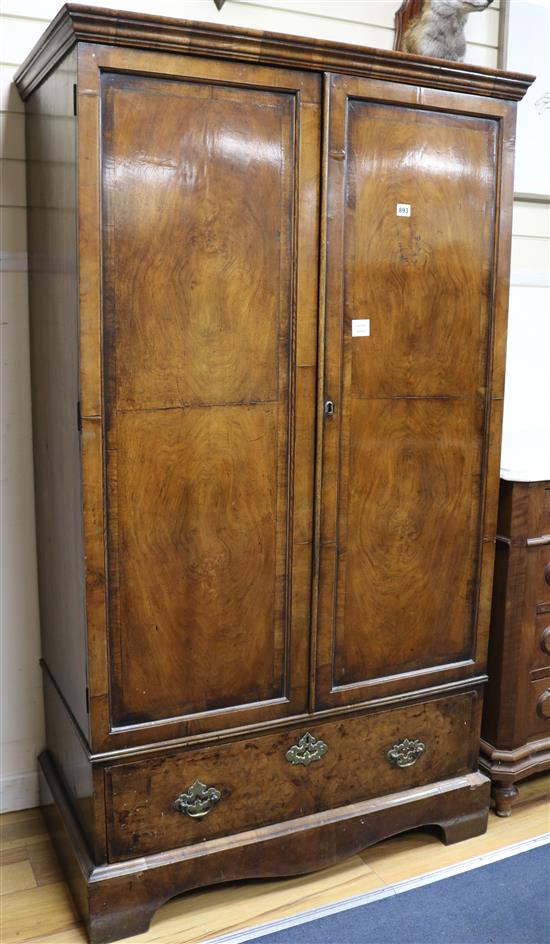 An early 18th century style walnut two door cupboard fitted one long drawer W.97cm